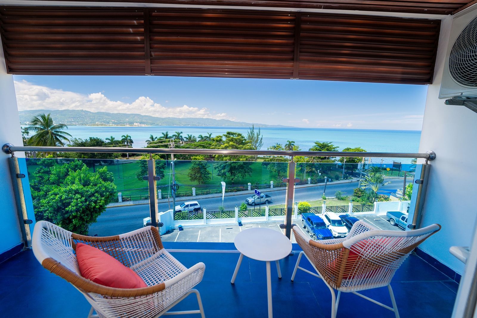 An image of a balcony in our Montego Bay hotel room that opens to the view of the coast of Montego Bay - Hotel 39, Jamaica (Montego Bay).