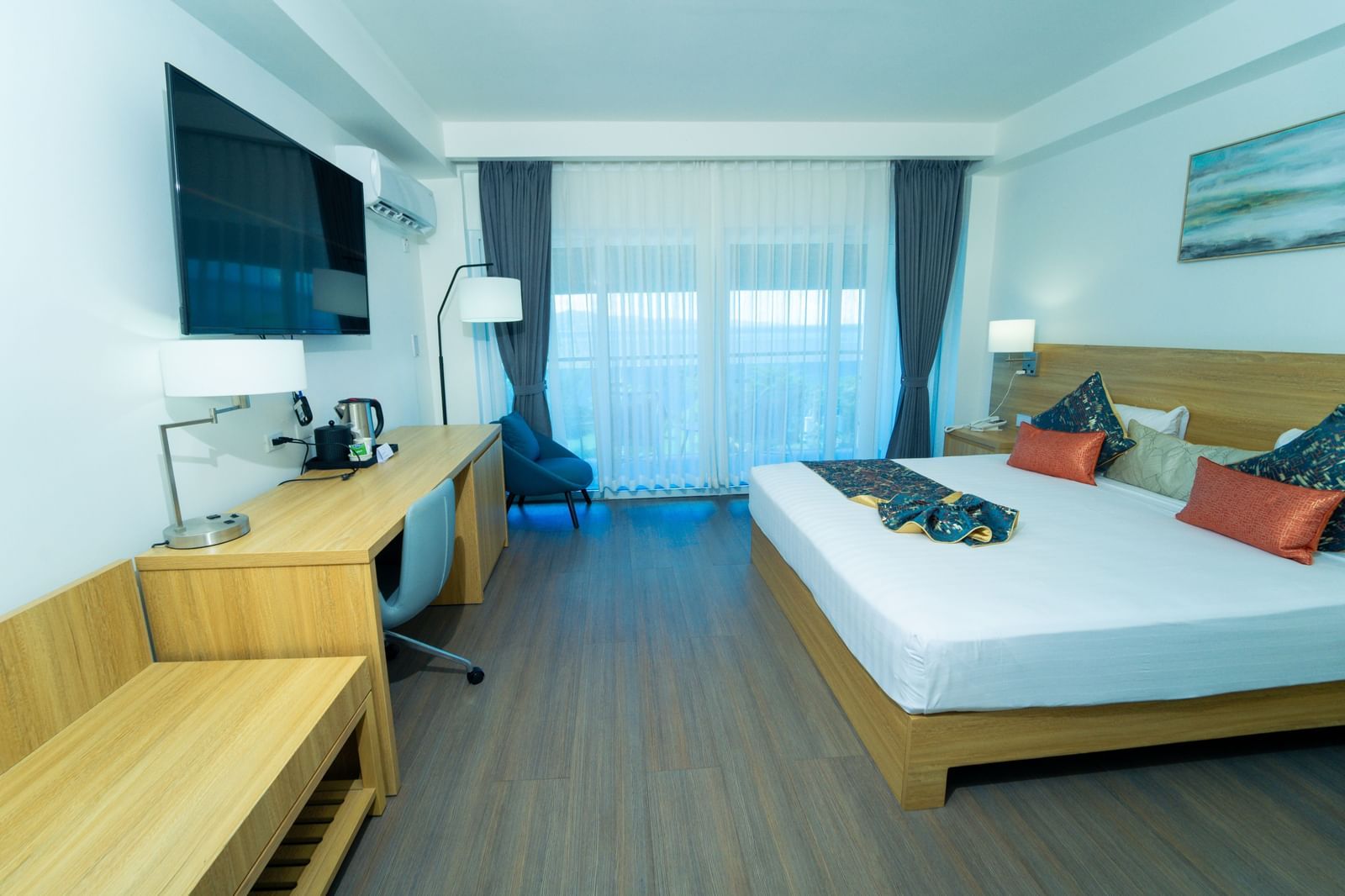 An overview of a hotel room in Montego Bay with a king size bed and a wall mounted television - Hotel 39, Jamaica (Montego Bay).