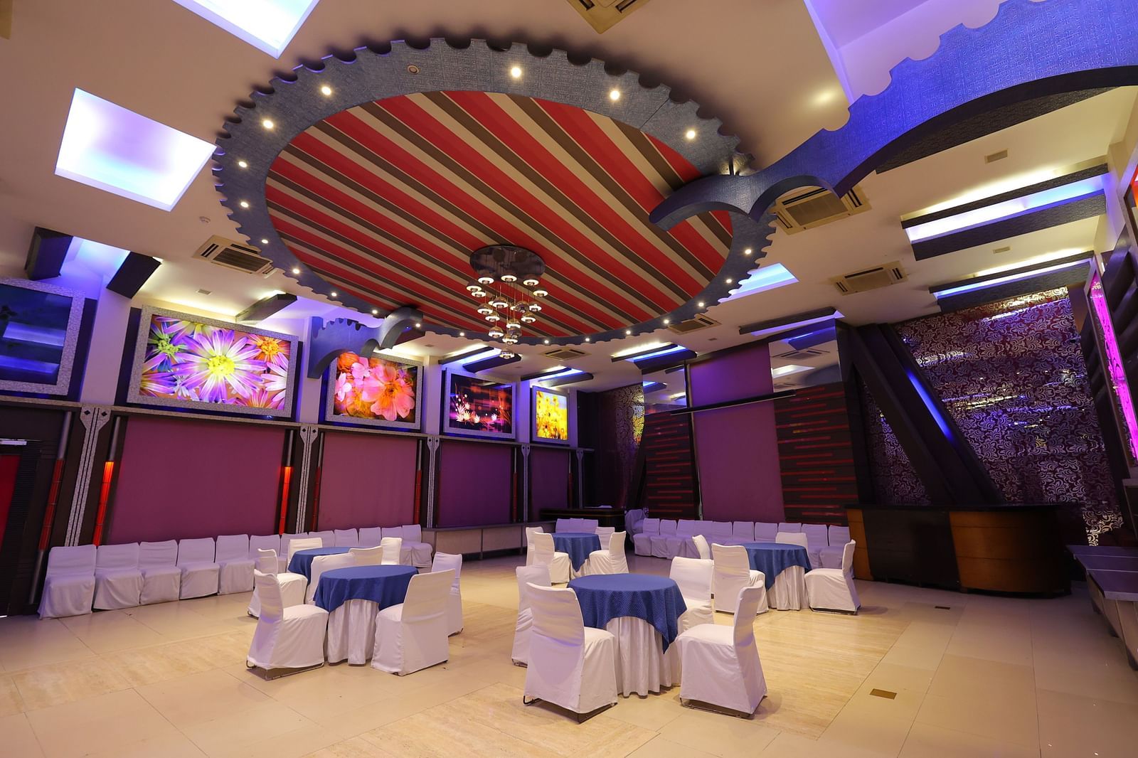 Image of Amar Mahal of hotel Amar with cluster seating arrangement  and ambient lighting 