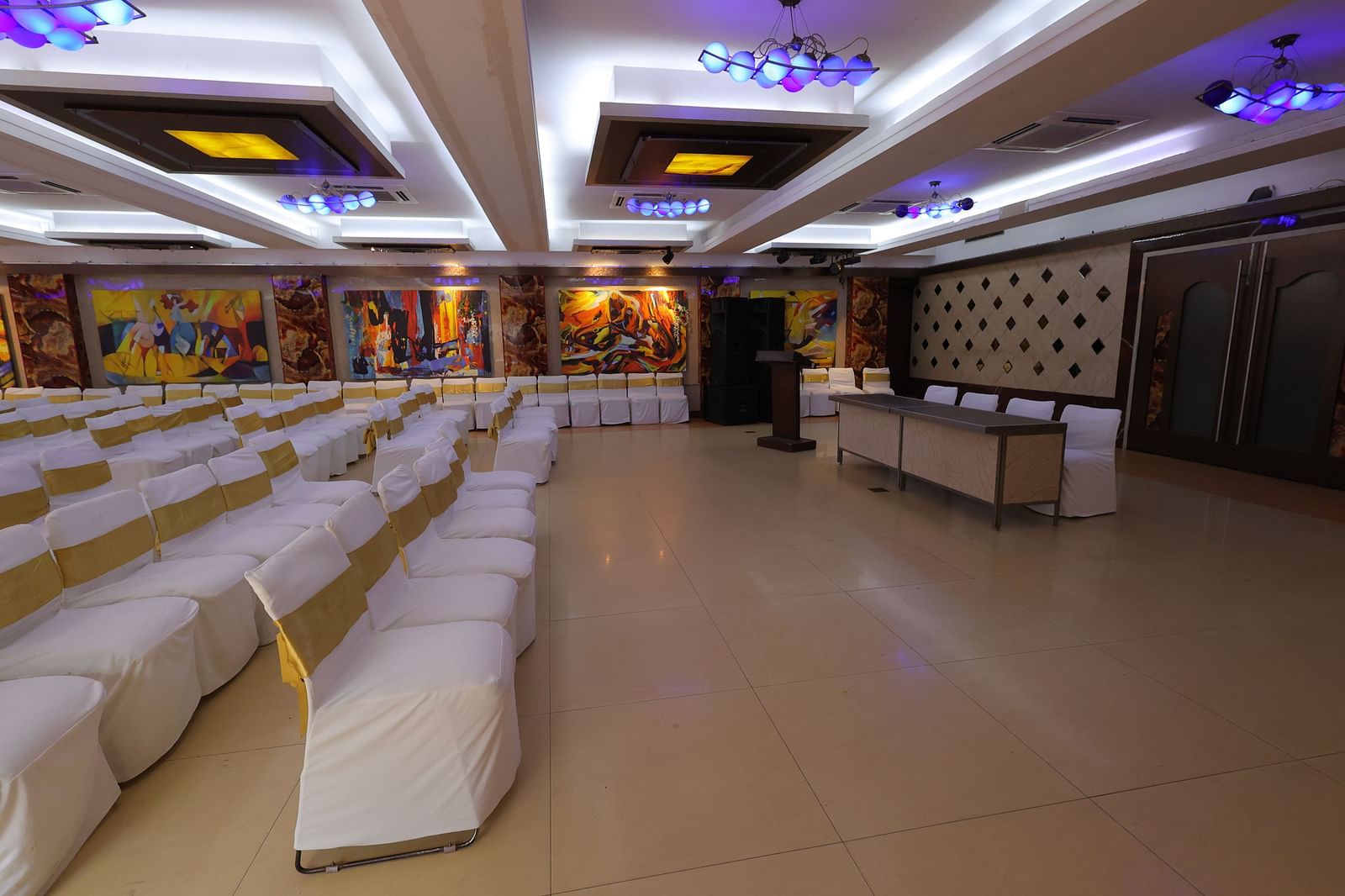 Close up image of Amar Convention Centre hall in Hotel Amar with classroom seating arrangement of chairs