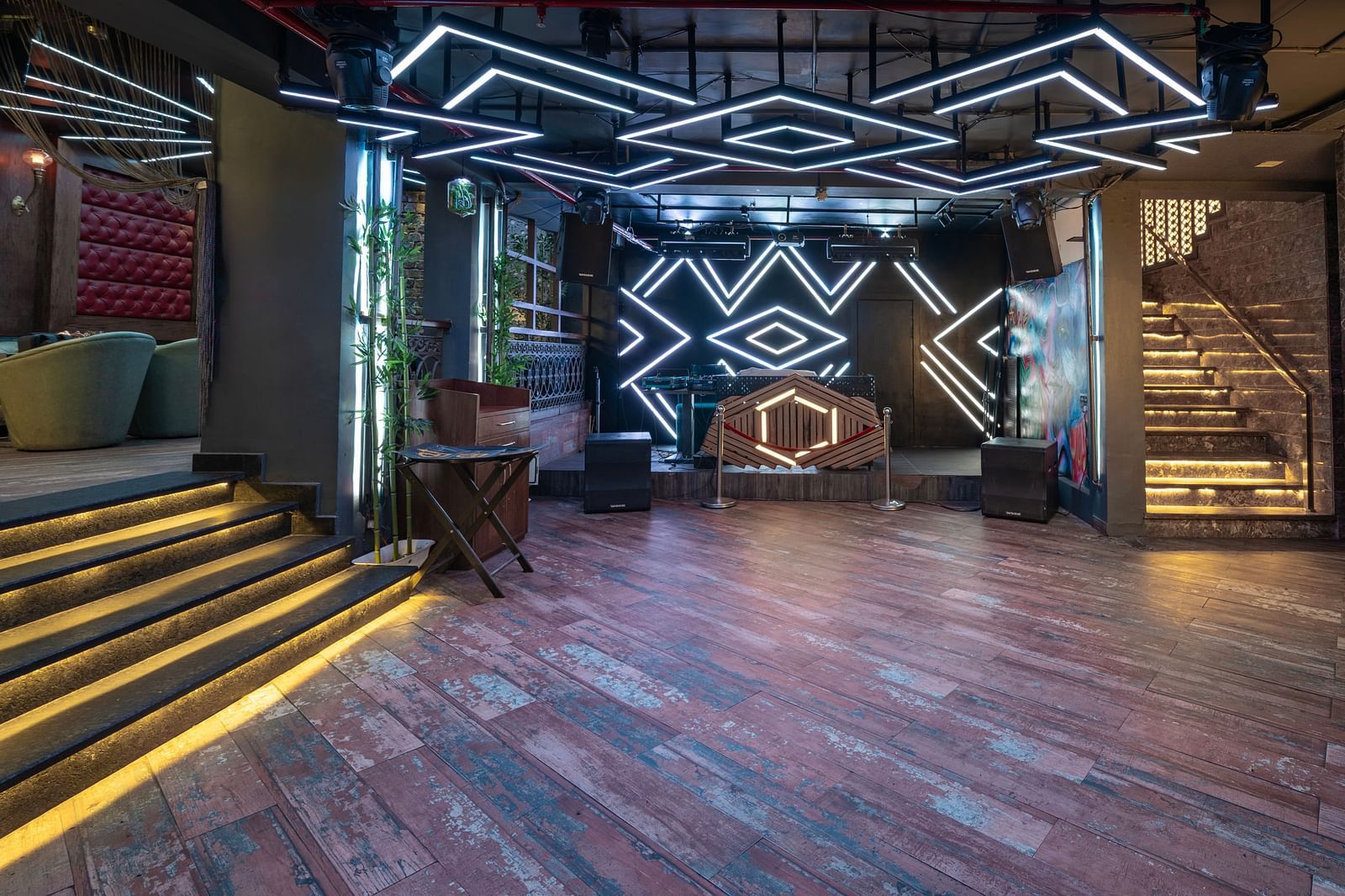 A dancing floor at Hotel Moti Palace featuring a DJ setup with colorful lighting, creating an energetic atmosphere for guests