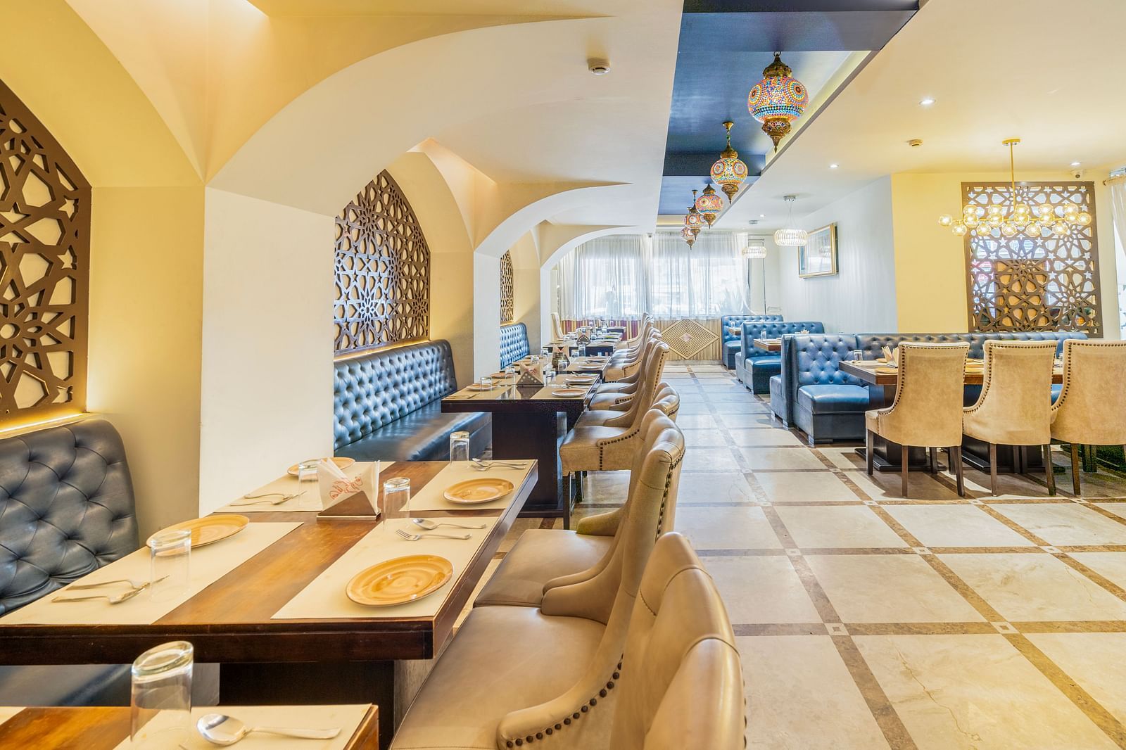 A wide angle view of the restraunt with royal look and comfy sofaHotel Moti palace .