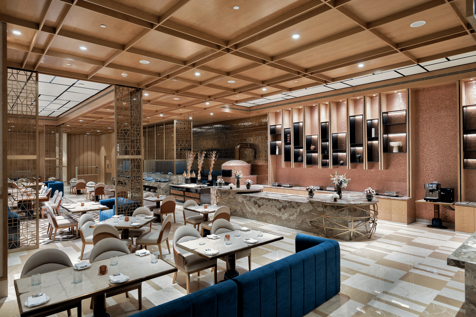 Contemporary dining area with ceiling panels and plush furnishings at Merlis Hotel, Coimbatore - 5-star restaurants in Coimbatore