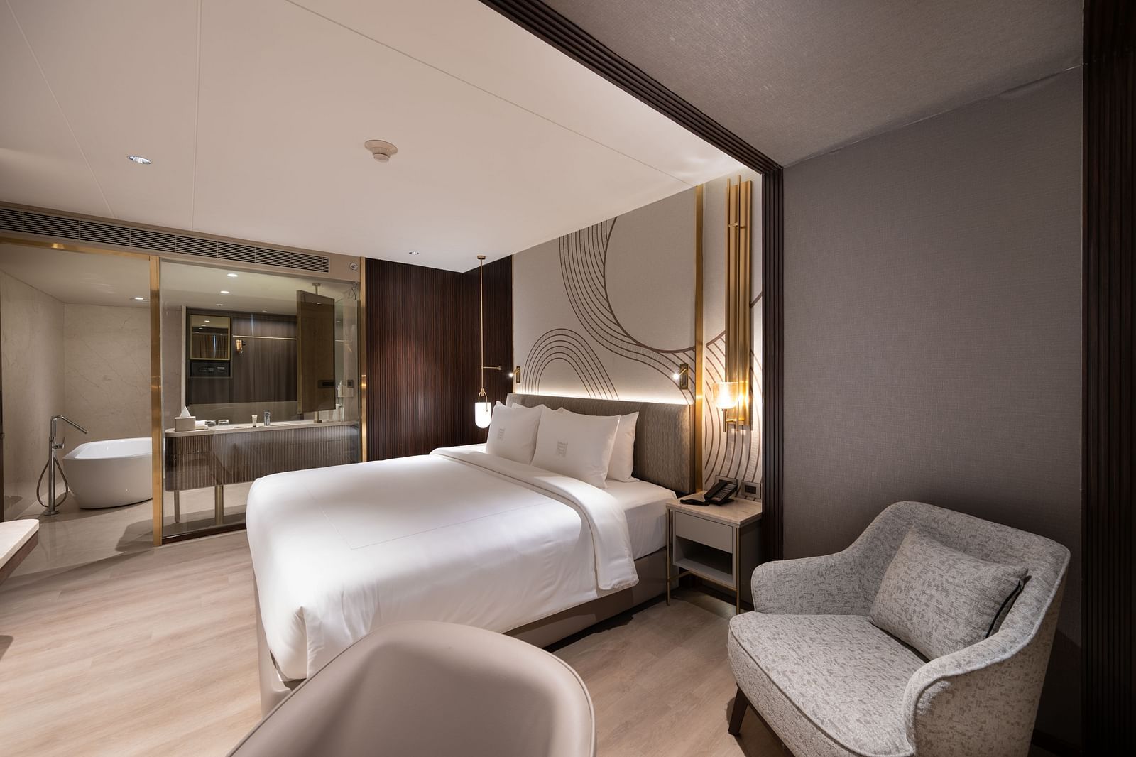 Elegant guest room with ambient lighting and modern furnishings at Merlis Hotel, Coimbatore.