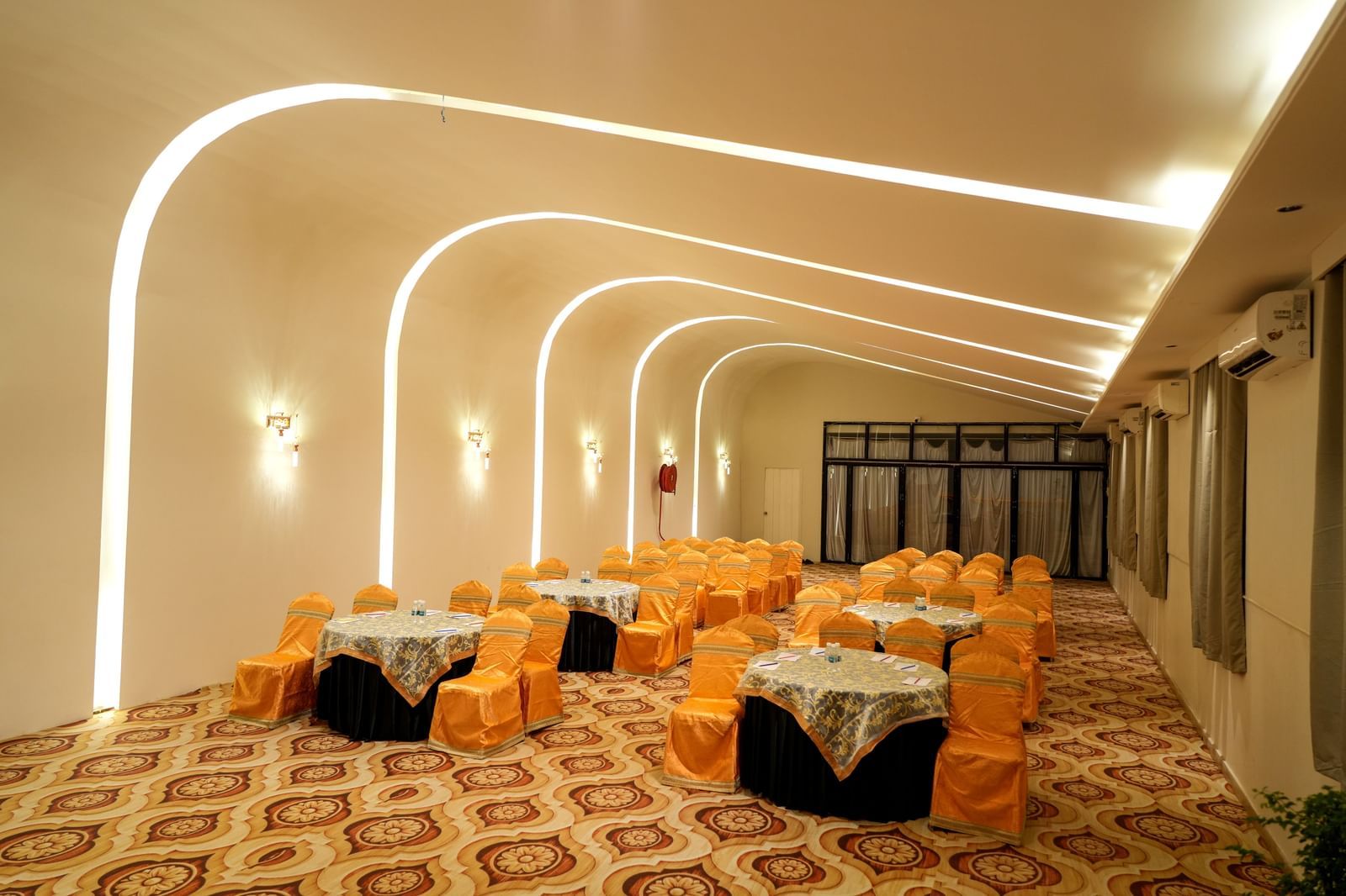 Elegant dining area with warm lighting and stylish seating at Pravasa Hotel Kolhapur.