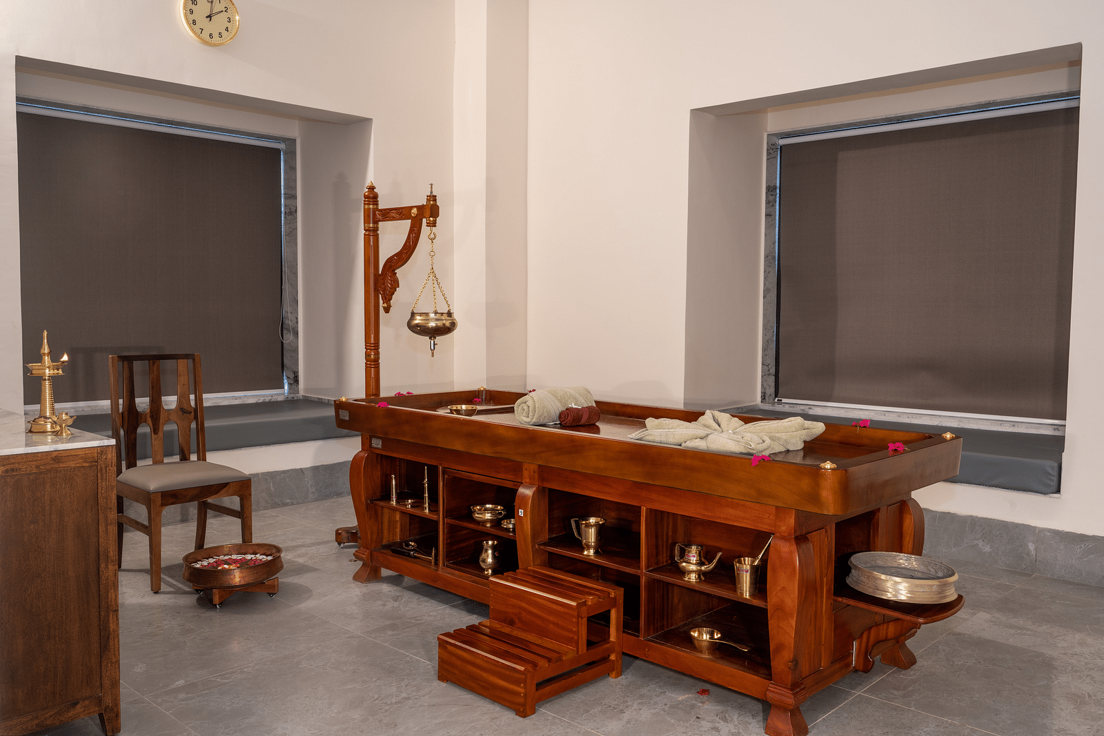 A treatment room with a table used for Shirodhara - Rajbagh Wellness, Udaipur