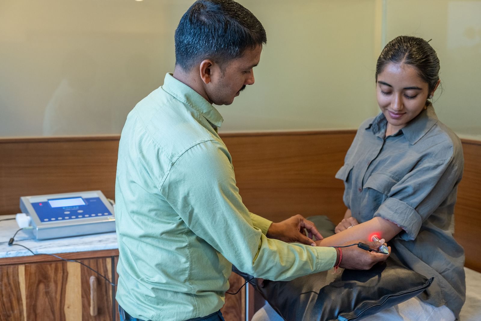 A doctor performing a check up on a patient - Rajbagh Wellness, Udaipur