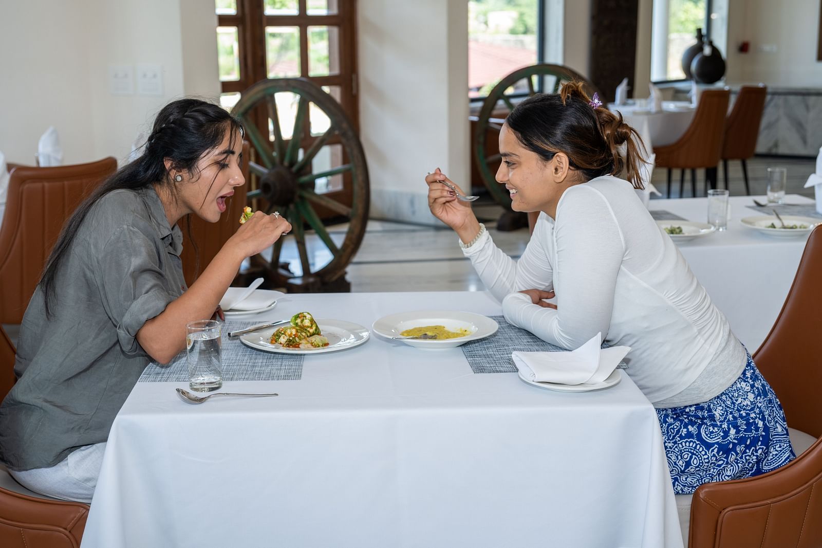 Two women have a meal at in-house restaurant in Udaipur - Rajbagh Wellness, Udaipur