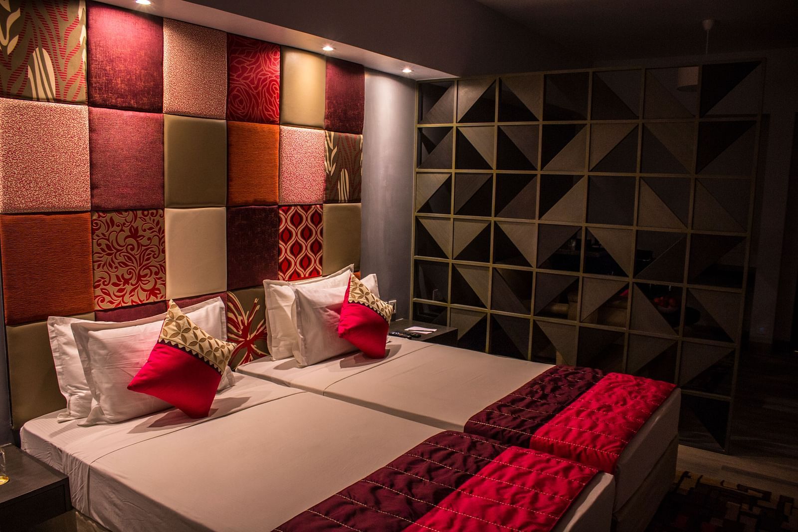 A room with twin beds and  pillows arranged on it  | Regency Tirunelveli By GRT Hotels