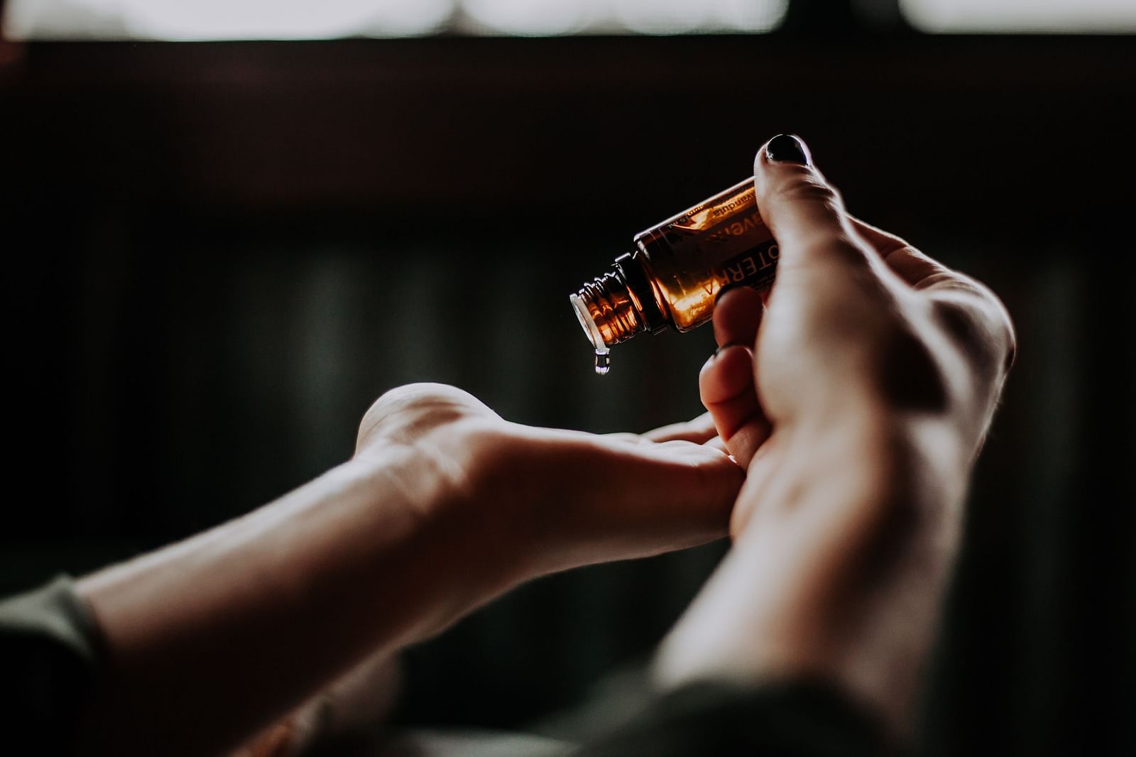 an image of a person using essential oil on their hands - Kerala Ayurveda