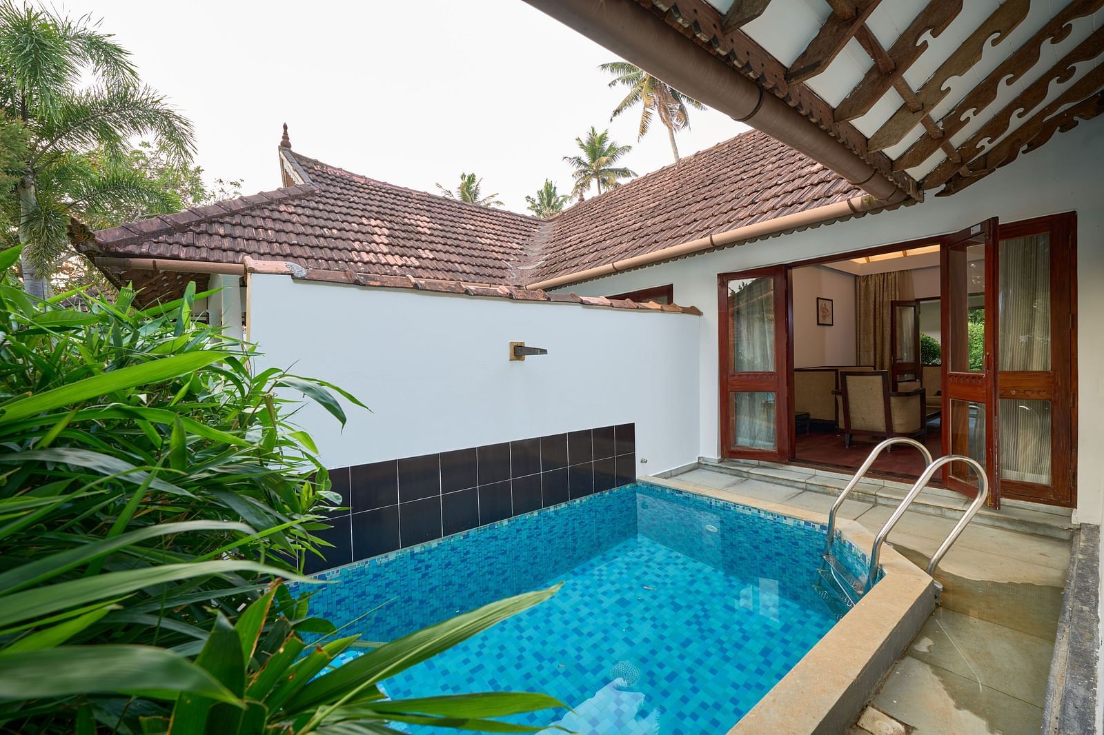 an image of a swimming pool just steps away from the room.- Rhythm Kumarakom