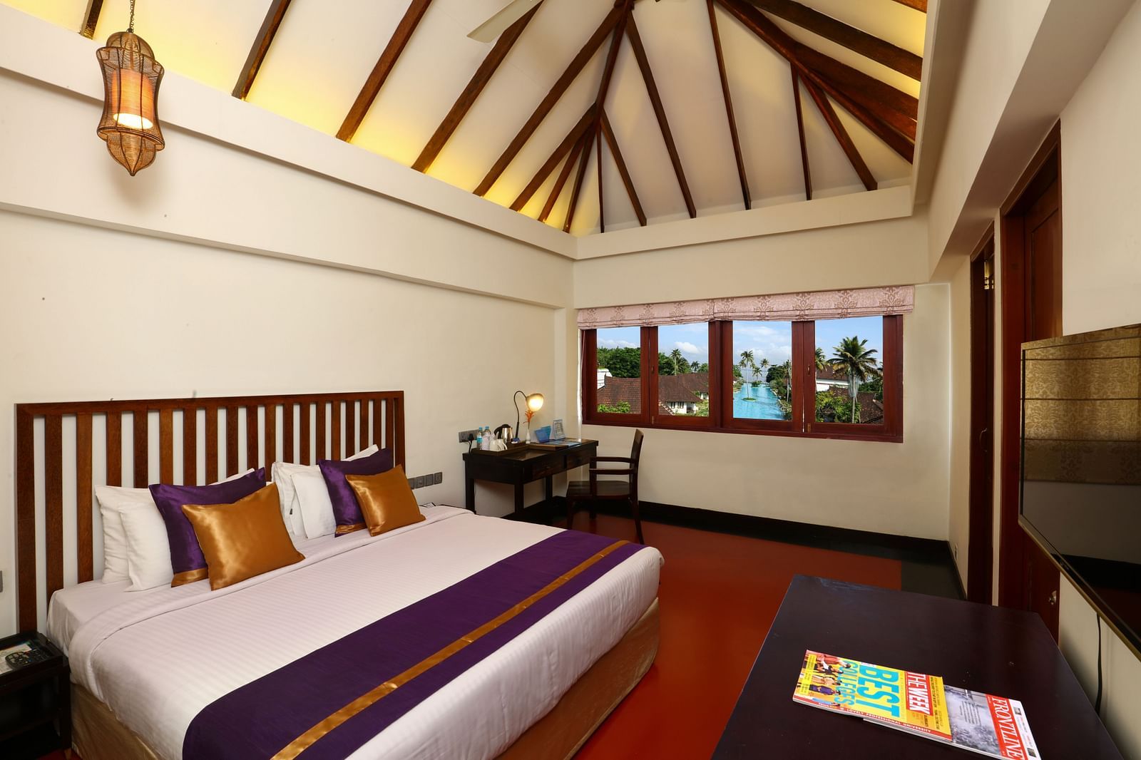 an image of a Lake View Terrace Suite Bedroom with a king bed and a light hanging from the ceiling - Rhythm Kumarakom.