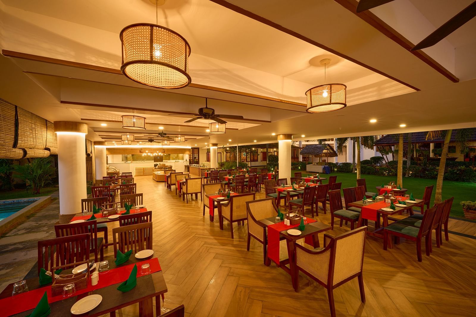 an image of dining area with tables and chairs inside the restaurant at Rhythm Kumarakom