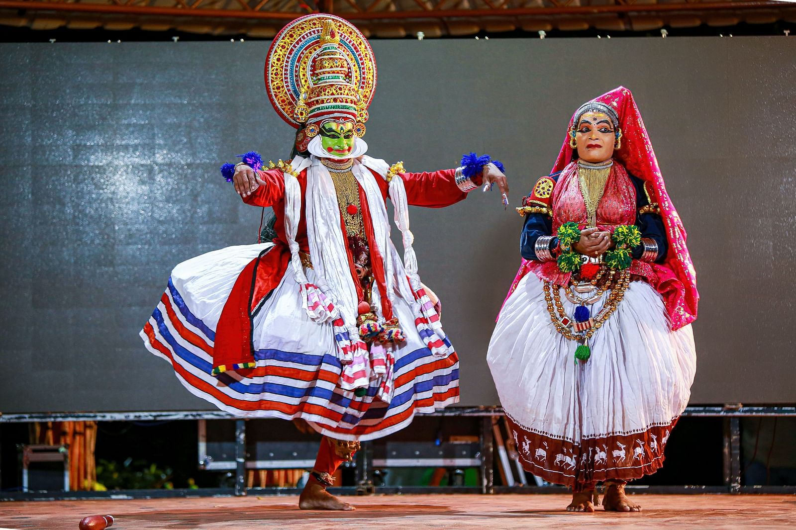 a couple dancing a traditional indian dance on stage