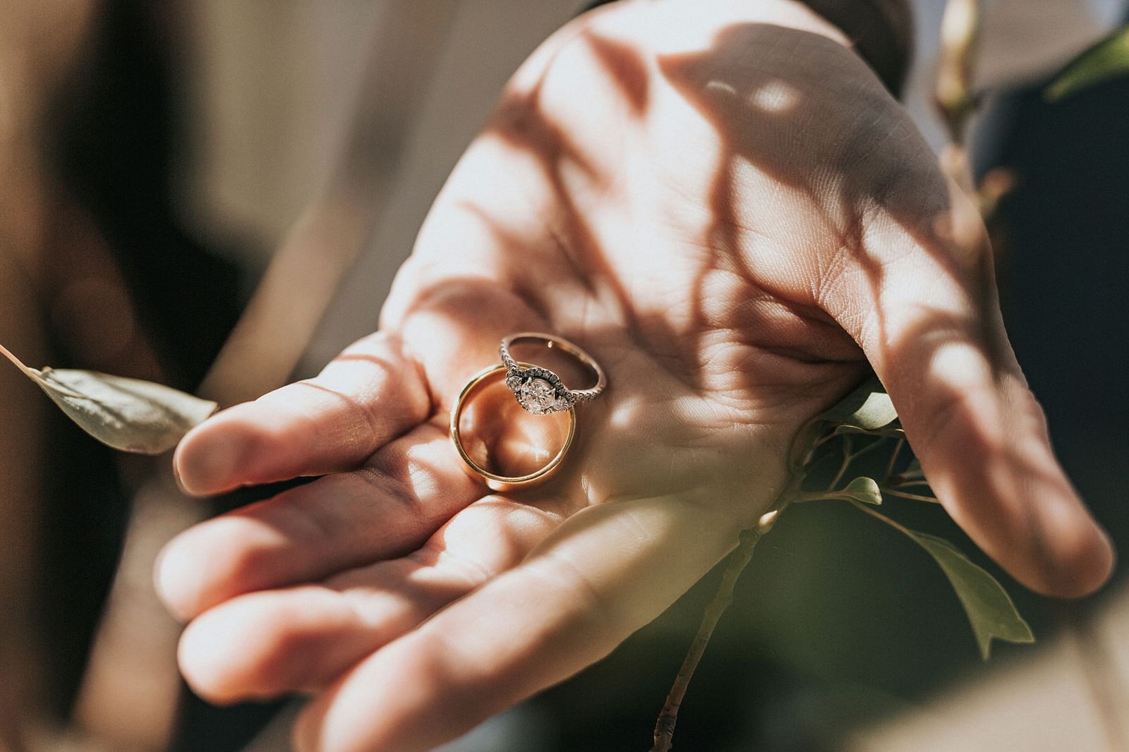a close up shot of a person holding a ring with sun light hitting the palm