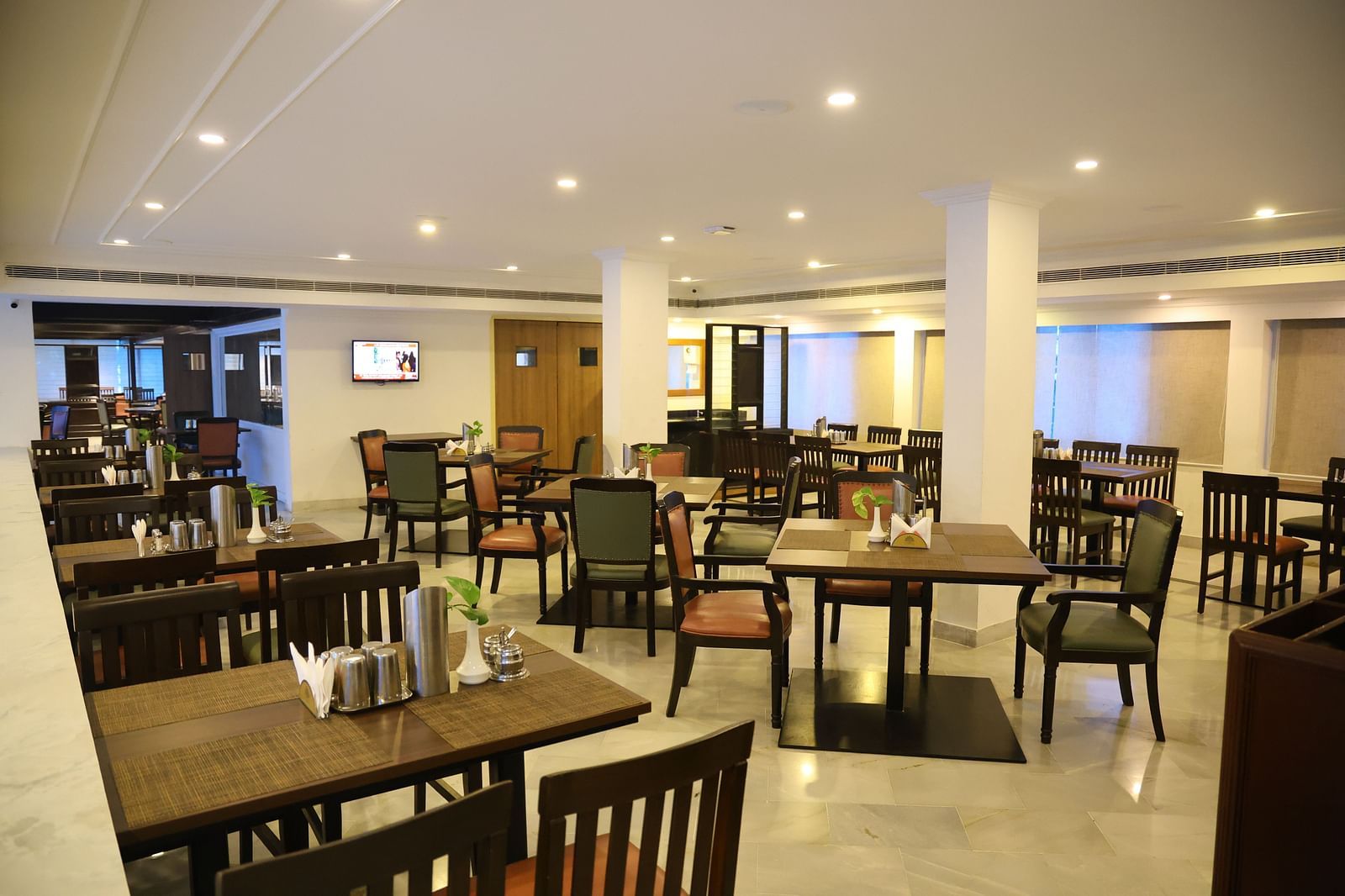 Indulge in classic delight at Padmam Veg Restaurant, with a cosy interior and wooden chairs.
