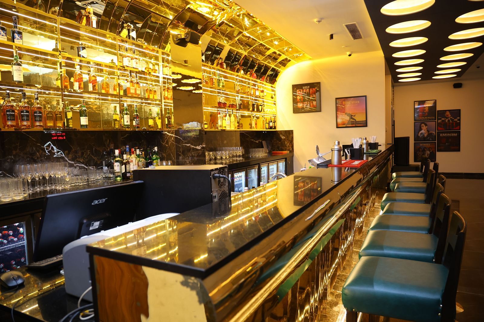 The bar at SRM Hotel Chennai, featuring a vibrant selection of cocktails and mixed drinks.