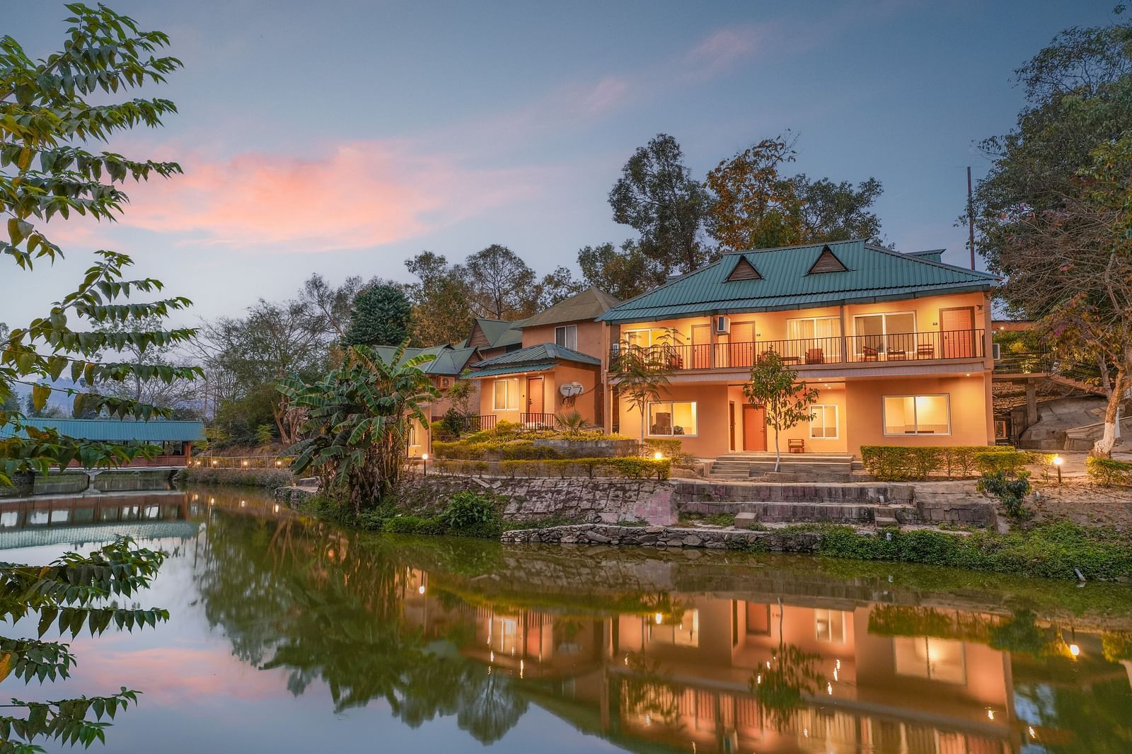 Facade view reflection on the lake at Summit Green Lake Tea Resort & Spa, Kaziranga