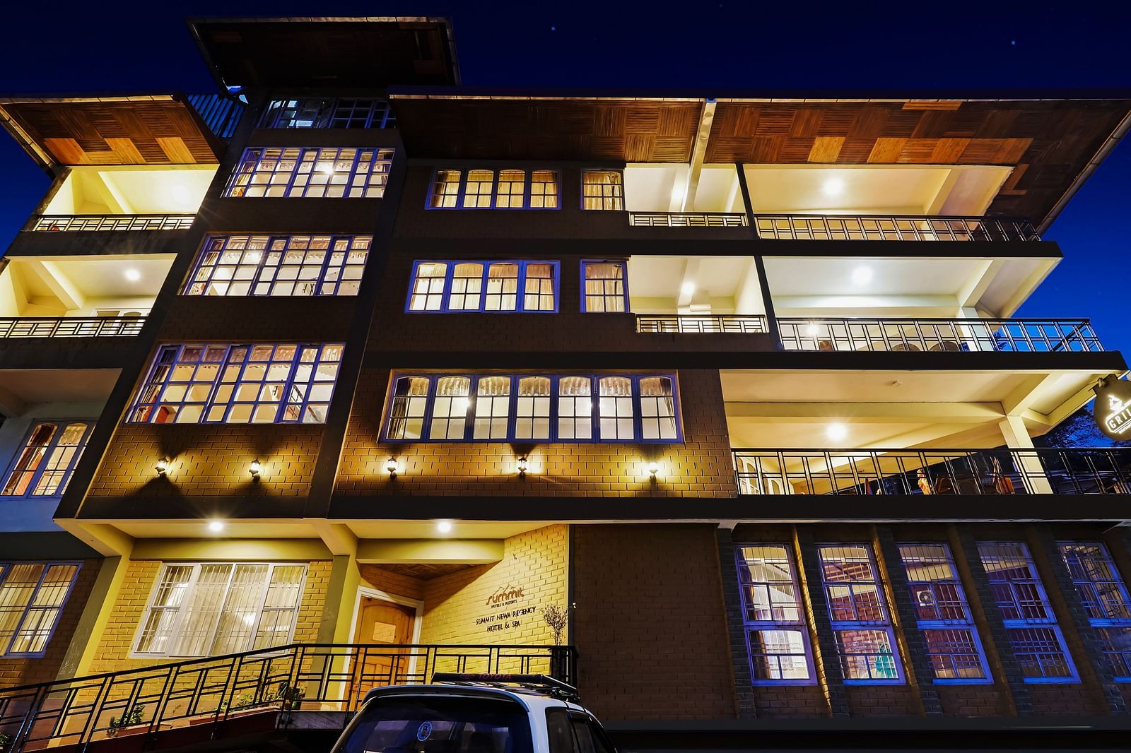 A low-high angle of a well-lit facade of Summit Newa Regency & Spa, Pelling