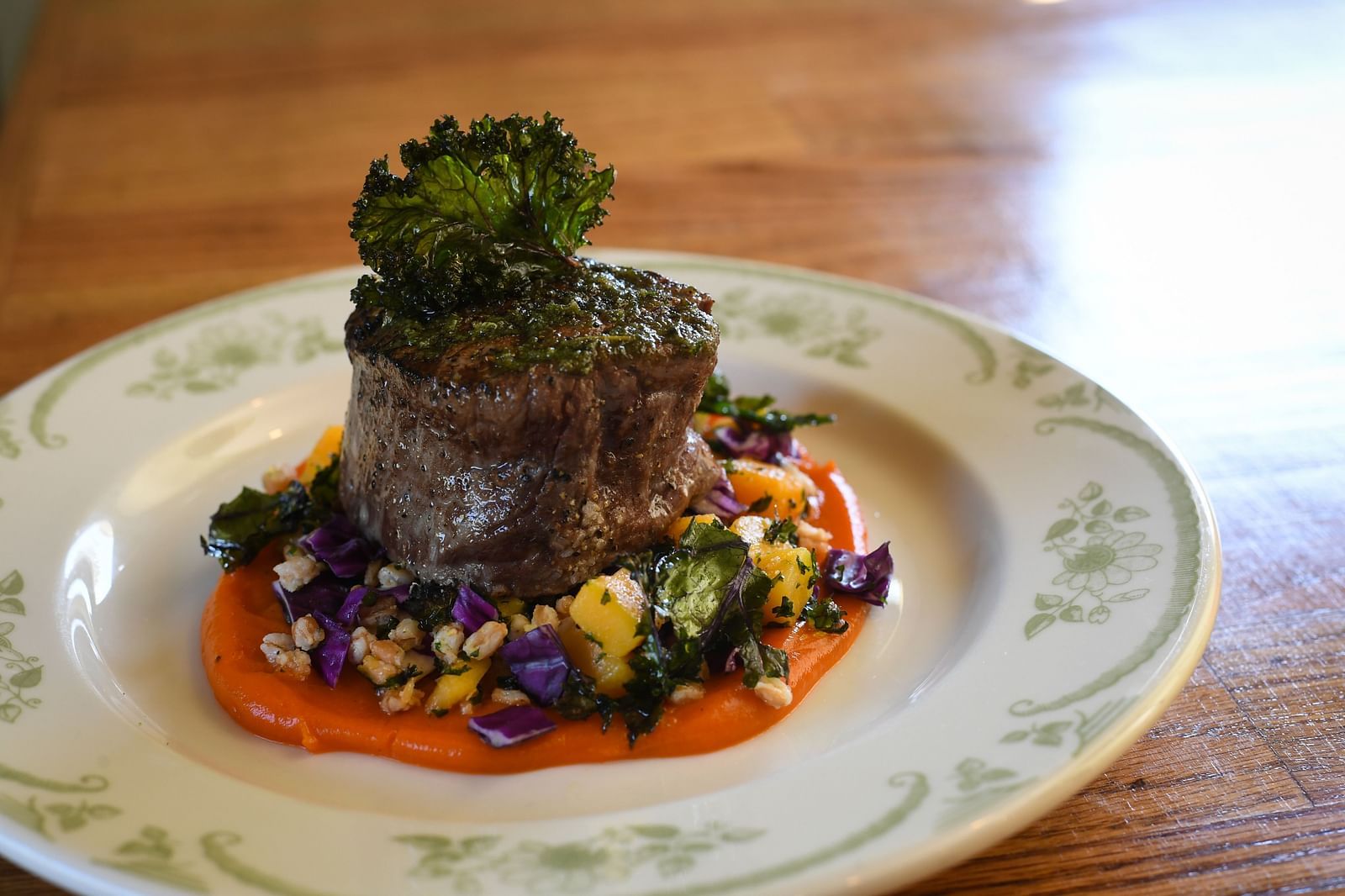 Close-up of a fancy dish with colorful garnish at The Grand Hotel & Ballroom, McKinney.