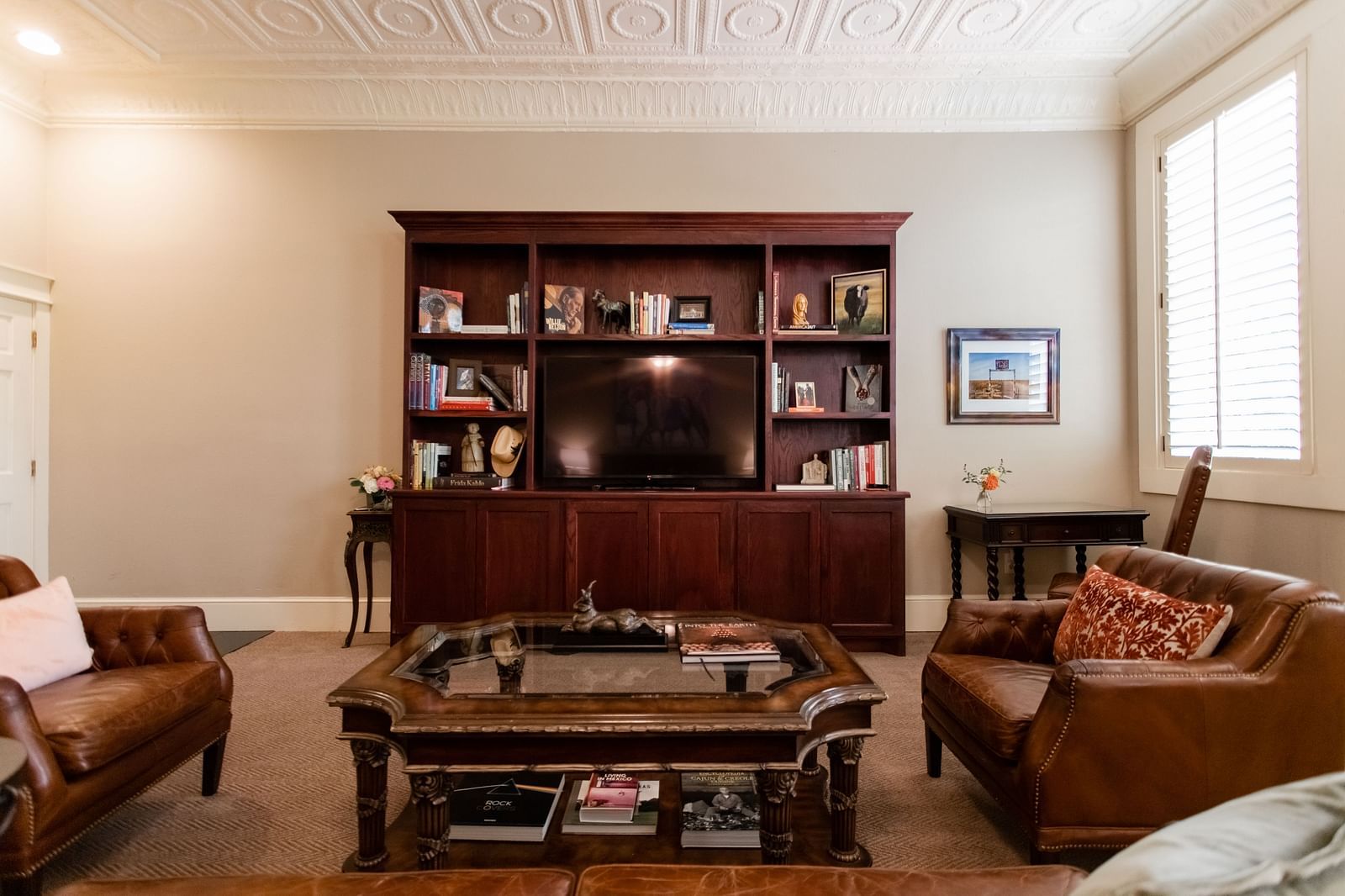 Lounge area with bookshelves, chairs, and coffee table at The Grand Hotel & Ballroom, McKinney.