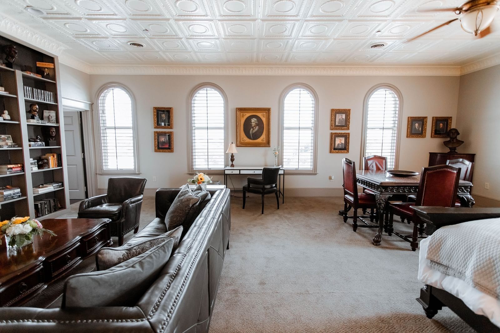  A spacious bedroom with a king-sized bed, wooden furniture, and soft lighting, creating a tranquil and elegant retreat - The Grand Hotel & Ballroom, McKinney