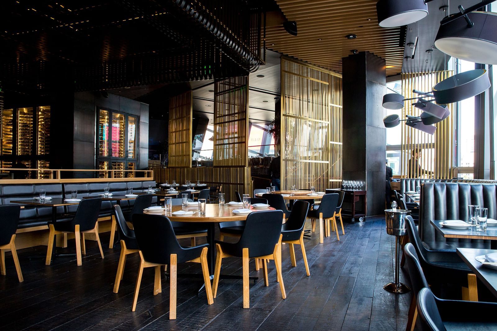 Seating arrangements inside a restaurant with the sun light shining through the windows