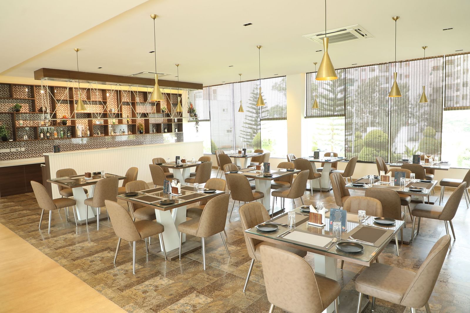 Brown tables and chairs in a restaurant dining area - Welcome Inn Hotels