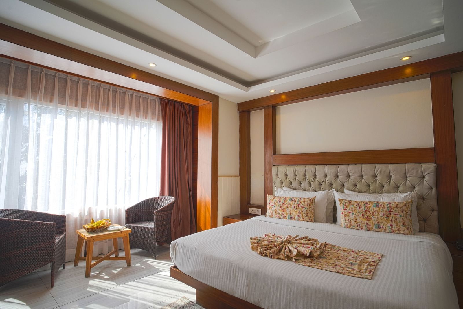 An image captured from an angle of the premium room without balcony featuring a bed, sofa, and a table - Yashshree, Mussoorie