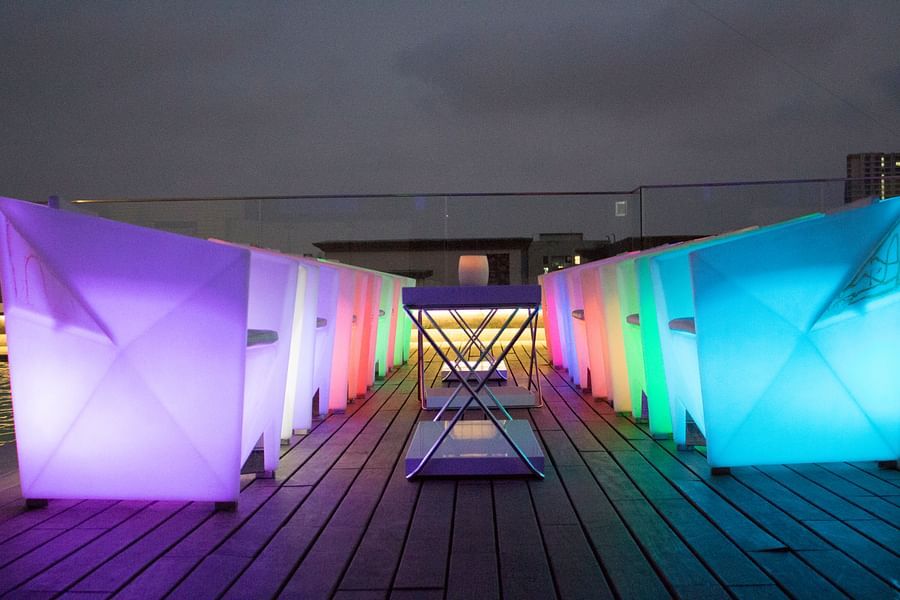 The Empresa Boutique Hotel - the rooftop area with colourful seats during nighttime