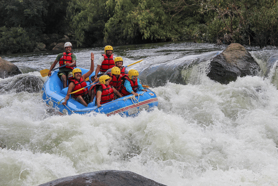 alt-text  A raft with six people in safety gear navigating through a rough river, showing intense concentration and teamwork in an exhilarating environment.