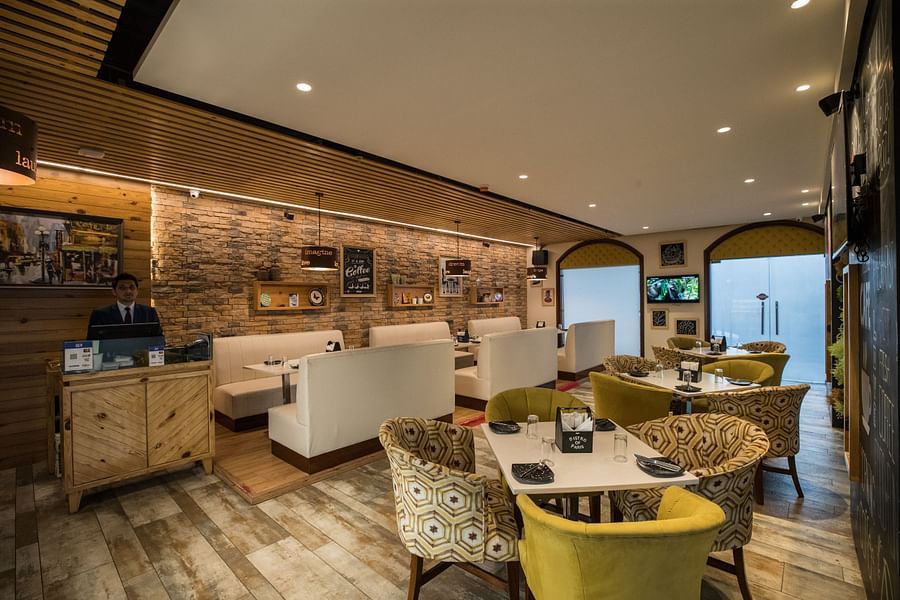 alt-text An elaborate seating arrangement in Cafe Hugs with Mugs at Ramada by Wyndham Kapurthala
