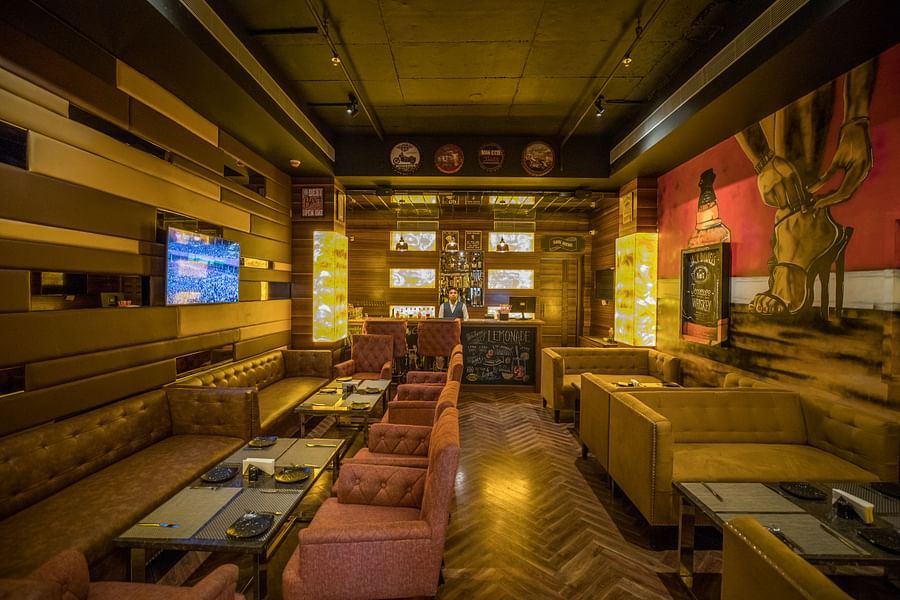 alt-text Interior of Paimana Bar decked with comfy sofa and well-decorated walls at Ramada by Wyndham Kapurthala