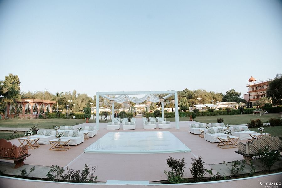 Wide shot of poolside wedding venue setup with floral mandap at Umaid Palace.