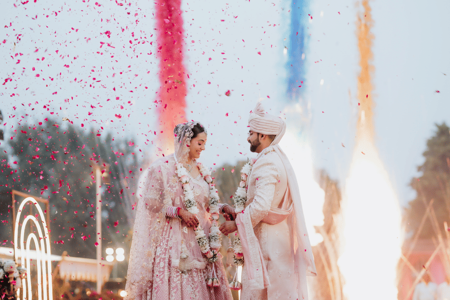 Couple performing wedding rituals with fireworks and vibrant colours at Umaid Palace