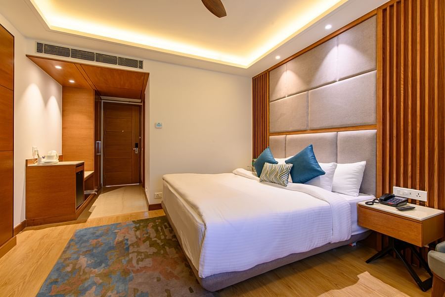 The interiors of the Classic Rooms in Pushkar featuring a bed, a sofa chair and exquisite furnishings at our resort 1316