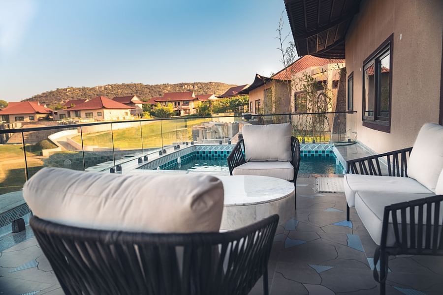 An image of a huge balcony with seating area which has chairs and a centre table - Ananta Spa & Resort, Jaipur