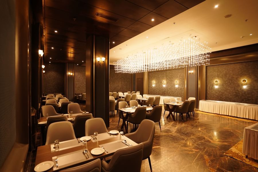 restaurant with tables and chairs at Classic Sapphire by Ananta