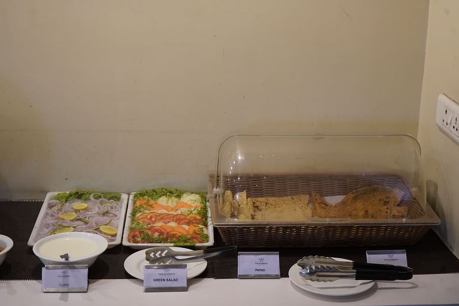 An image of buffet area featuring vegetable salads and breads at the restaurant of Five Elements Hotels North Avenue, Delhi