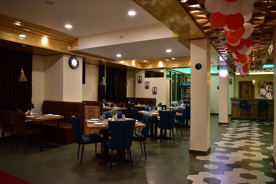 alt-text dining area with attractive interior and indoor seating arrangement decorated with red and white balloons at Hotel Montana Vyoo