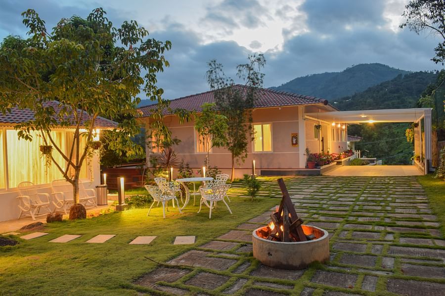 campfire in front of a room next to a garden at Ibex Stays & Trails, Kotagiri