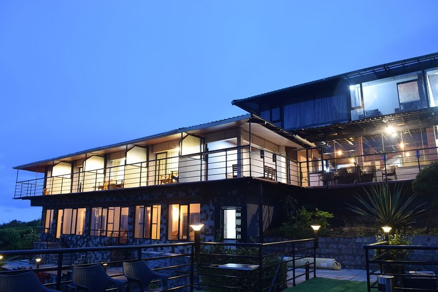 A night shot of the facade of the resort with blue sky in the background | Ibex Stays and Trails