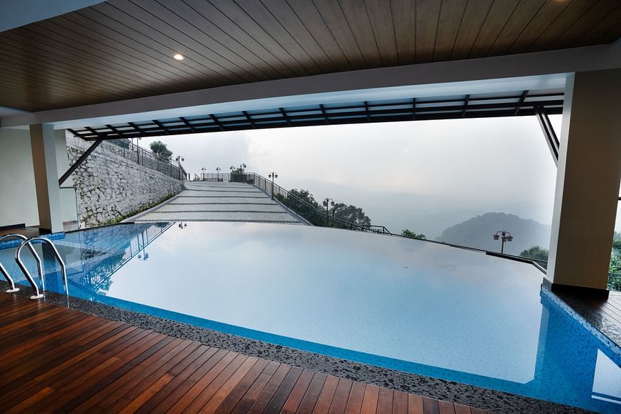An outdoor swimming pool at the resort in Kakkadampoyil