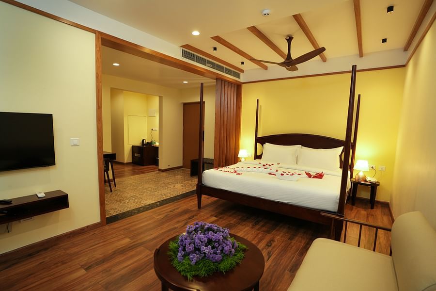 A bed in a room with TV  | Misty Queen by Dimora, Kakkadampoyil