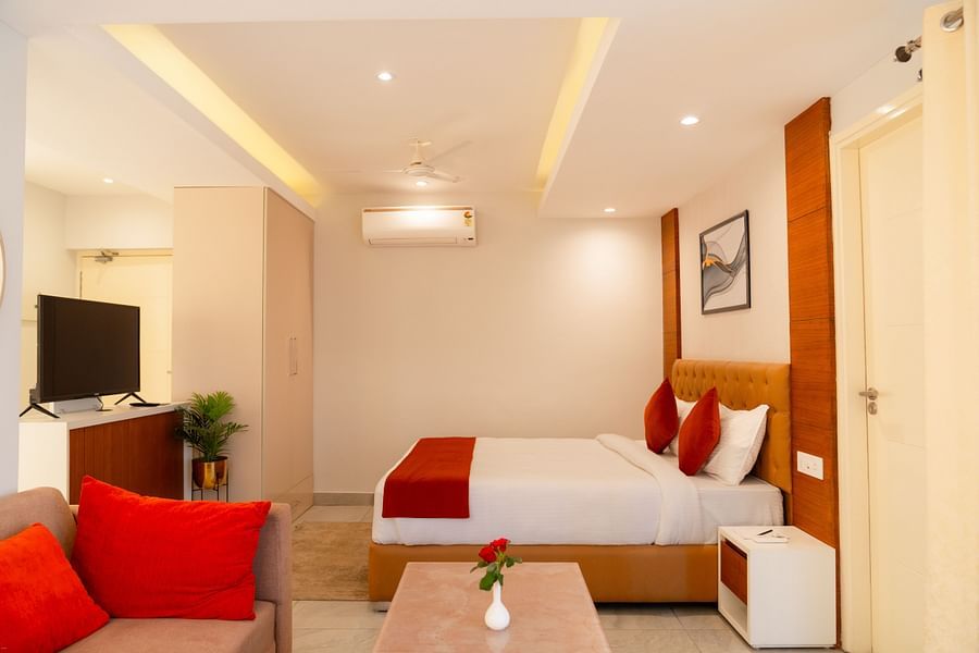 A large bed facing the television in a Standard Room at Montclair Ananta, Elite.