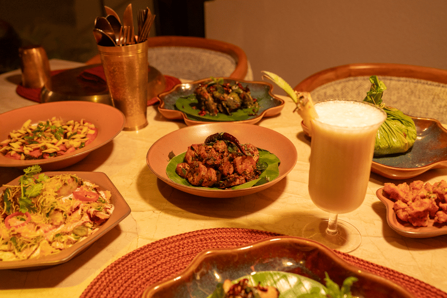 Assorted dishes and beverages served on a dining table at Jamun restaurant - Symphony Resorts