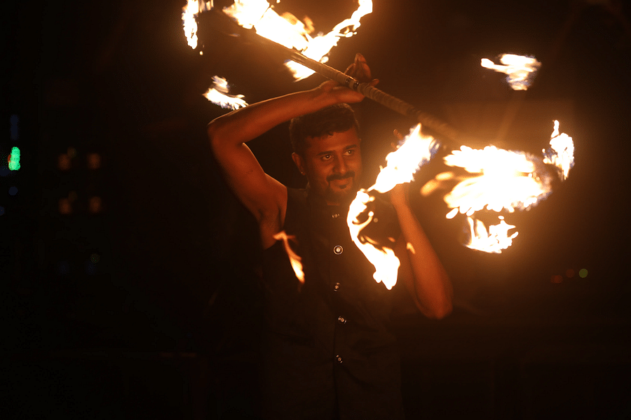 alt-text A man performing a fire display at Nysa Skybar, Bengaluru.