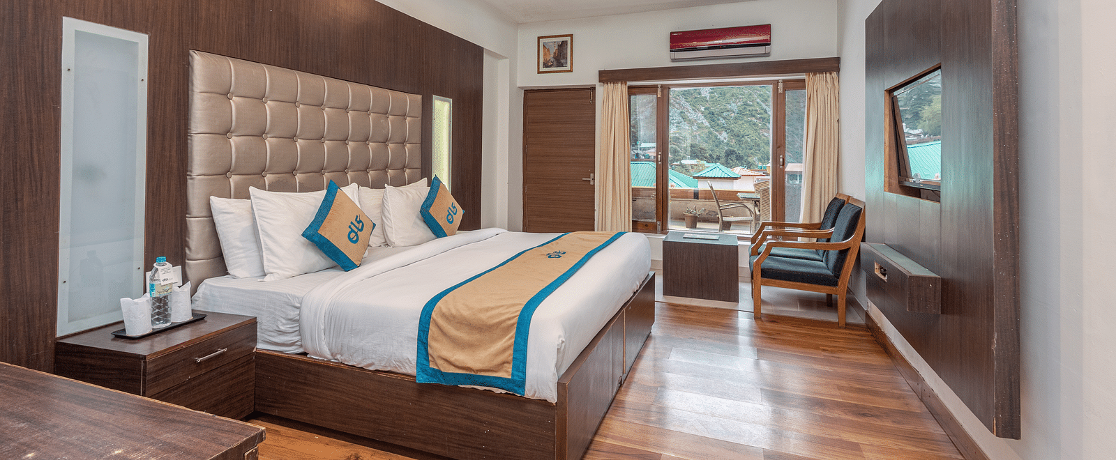 Overview of Premium Room at DLS Spring Valley Resort Dharamshala featuring a king size bed, chair and a balcony