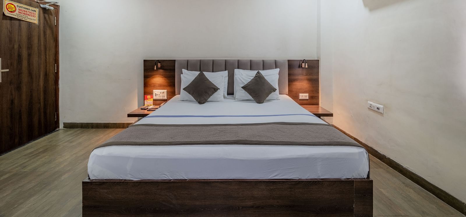 A modern guest room with a comfortable bed, TV, and large window at Hotel Highway King Shahpura.