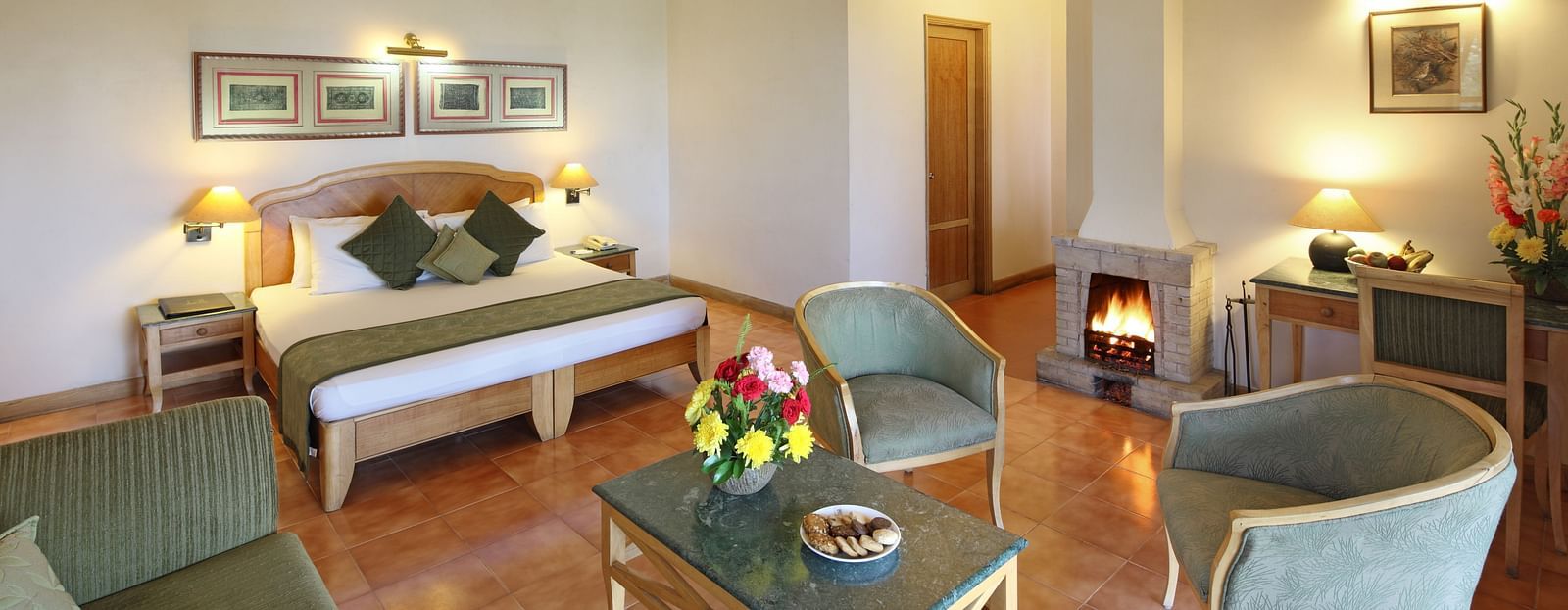 Premium cottage room featuring a cosy bed and a small living area with a sofa and coffee table